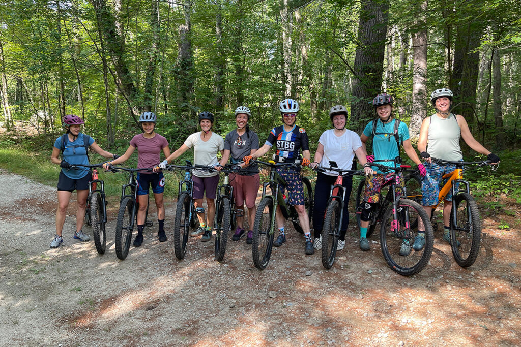 Group of 8 women on mountain bikes.