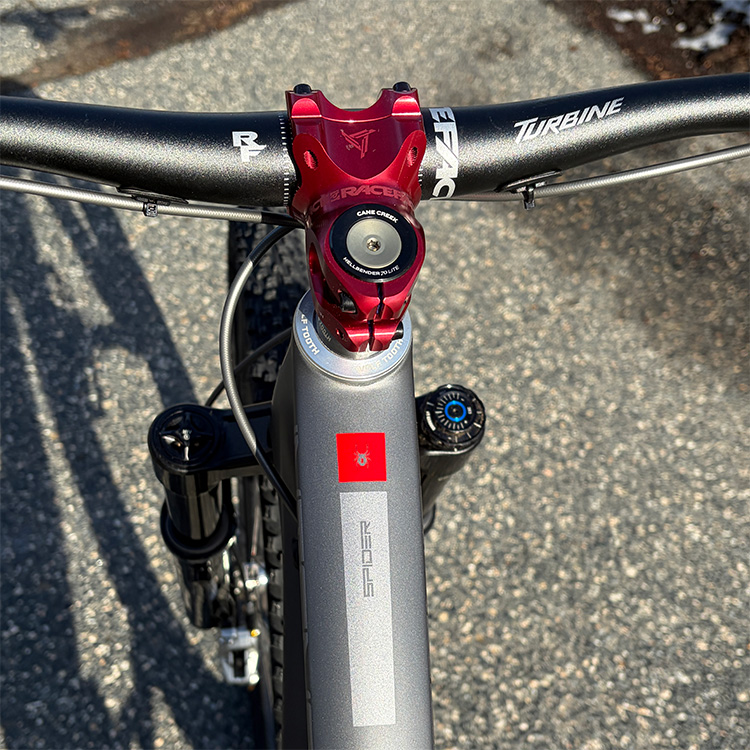 Close up of red stem on grey Spider bike.
