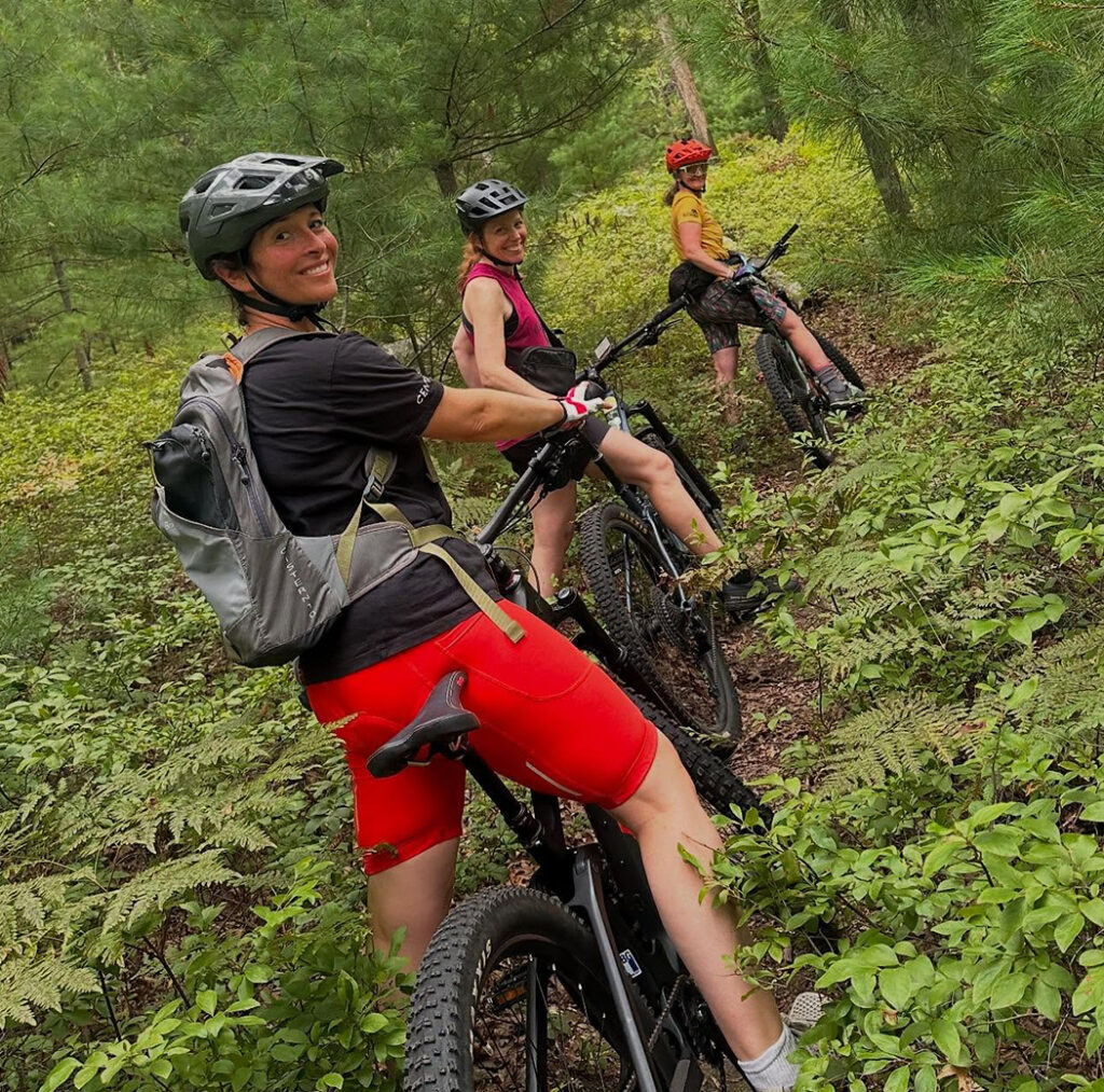 Three riders on the trail looking back at the camera.