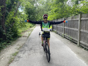 A rider, pictured from behind, riding with no hands.