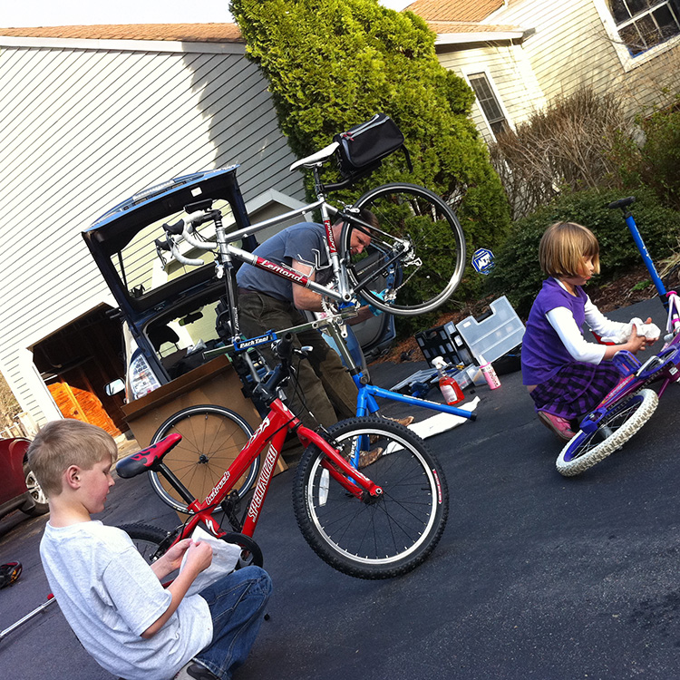 Steve and the kids work on their bikes (in 2011)
